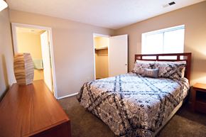 Bellevue triplex for rent - a bedroom with a bed and a dresser and a closet