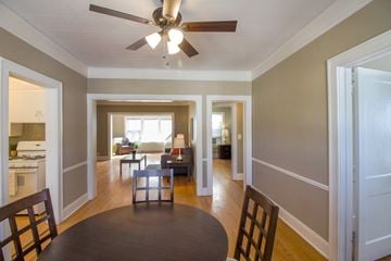 Omaha apartment for rent - a dining room and living room with a table and a ceiling fan