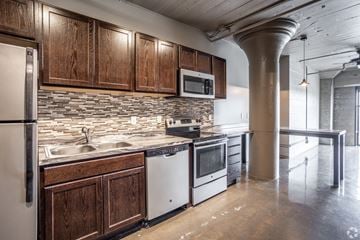 Des Moines apartment for rent - A kitchen with wooden cabinets and stainless steel appliances.