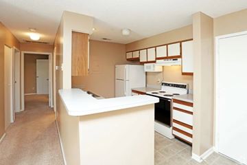 Lincoln apartment for rent - A kitchen with a white counter and brown cabinets.