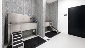 Bentonville apartment for rent - A bathroom with a toilet, sink, and a black door.