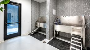 Bentonville apartment for rent - A bathroom with a black and white tiled wall and a stainless steel sink.
