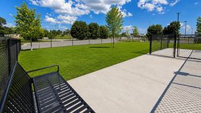 Bentonville apartment for rent - A park with a black metal fence and a concrete path.
