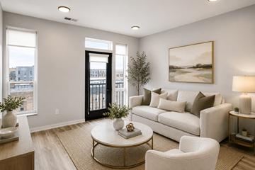 Omaha apartment for rent - A living room with a white couch, a coffee table, and a painting on the wall.