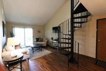 Lincoln townhouse for rent - a spiral staircase in a living room with a couch and a table