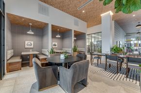 Bentonville apartment for rent - A modern dining area with a round table and grey chairs.