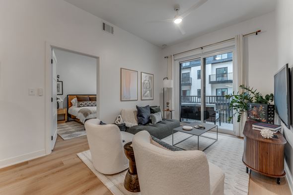 Bentonville apartment for rent - A living room with a white sofa and a grey couch.
