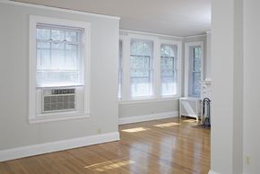 Omaha apartment for rent - an empty living room with a wood floor and windows