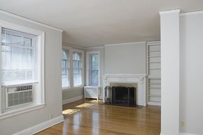 Omaha apartment for rent - a living room with a fireplace and a wooden floor