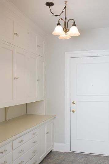 Omaha apartment for rent - a white kitchen with white cabinets and a light