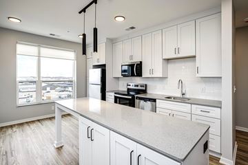 Omaha apartment for rent - A kitchen with white cabinets and a large island.