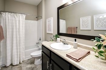 Upscale bathroom with designer fixtures & ceramic tiled floors