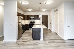 Bellevue apartment for rent - Kitchen with a large island and stainless steel appliances at Belle Point in Bellevue, NE