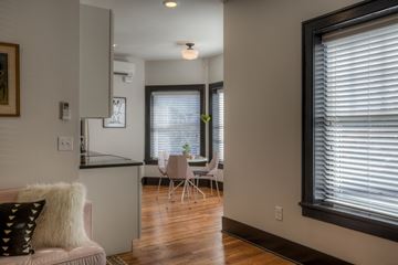 Omaha apartment for rent - A living room with a couch and a dining table.