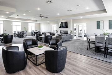 Lexington apartment for rent - a large living room with chairs and tables and a tv
