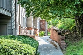 Council Bluffs apartment for rent - Beautiful walkway with plants  at Deer Park Apartments in Council Bluffs, IA