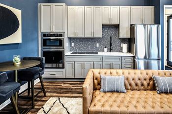 Resident lounge area with fireplace, bar, and kitchen area