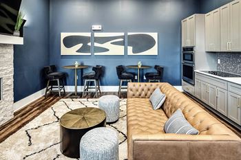 Resident lounge area with fireplace, bar, and kitchen area