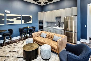 Resident lounge area with fireplace, bar, and kitchen area