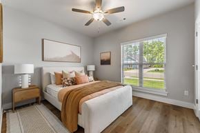 Rogers apartment for rent - A bedroom with a large bed and a ceiling fan.