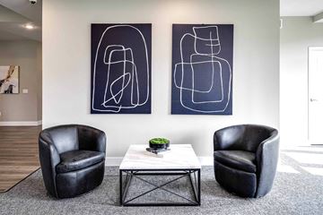 Wayne apartment for rent - two chairs and a table in a living room with paintings on the wall