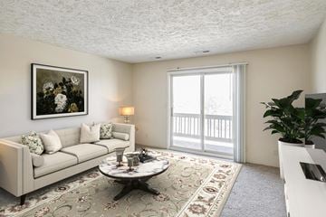 Papillion apartment for rent - A living room with a couch, coffee table, and a painting on the wall.