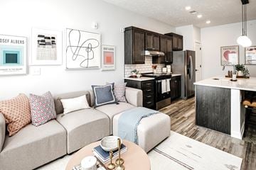 Council Bluffs apartment for rent - A modern living room with a beige couch and a coffee table.