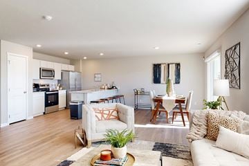 Elkhorn apartment for rent - A modern living room with a white couch and a coffee table.