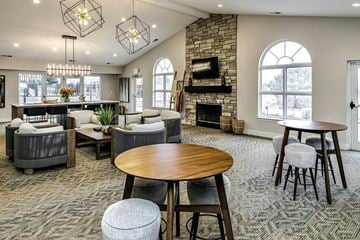 Bellevue apartment for rent - a large living room with tables and chairs and a fireplace