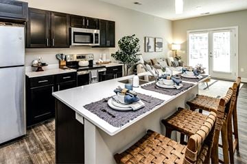 Omaha apartment for rent - a kitchen and living room with a table and chairs