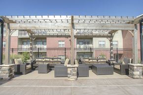 Lincoln townhouse for rent - a patio with tables and chairs in front of a building