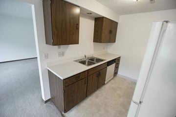 Lincoln apartment for rent - A kitchen with brown cabinets and a white countertop.