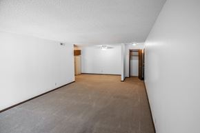 Lincoln apartment for rent - A long, narrow hallway with a carpeted floor and white walls.