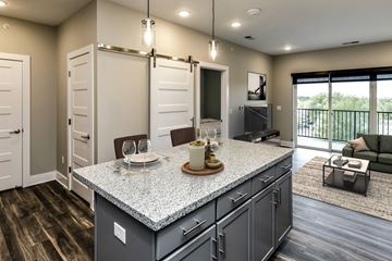 Omaha apartment for rent - a kitchen with an island and a living room with a couch