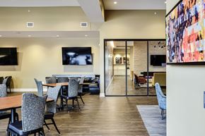 Omaha apartment for rent - A modern dining room with a long table and chairs.