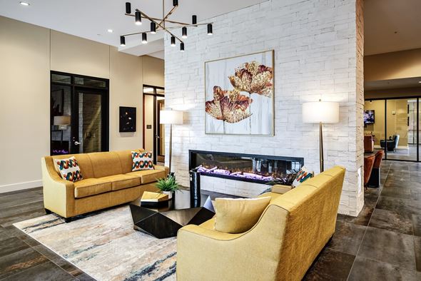 Omaha apartment for rent - A living room with a fireplace and a painting above it.