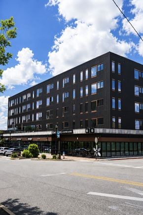 Springdale apartment for rent - A black building with a parking lot in front of it.