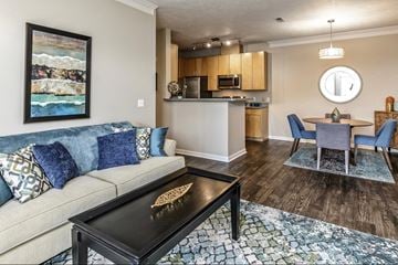 Omaha apartment for rent - a living room with a couch and a table and a kitchen
