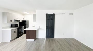 Independence apartment for rent - A kitchen with a black door and a white countertop.