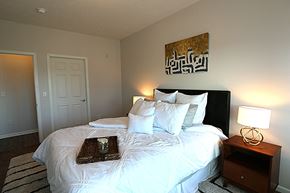 Omaha apartment for rent - a bedroom with a bed with white sheets and pillows