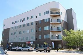 Omaha apartment for rent - a large building with cars parked in front of it
