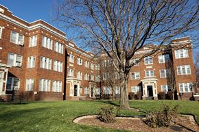 Omaha apartment for rent - a large brick building with a large tree in front of it
