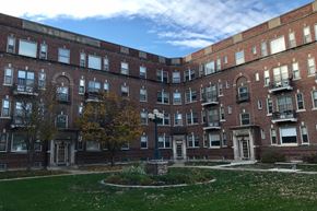 Omaha apartment for rent - a large brick building with green grass in front of it