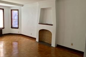 Omaha apartment for rent - an empty living room with a fireplace and wooden floors