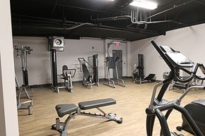 Omaha apartment for rent - a workout room with various exercise equipment in a studio space