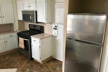 Omaha apartment for rent - a kitchen with stainless steel appliances and white cabinets