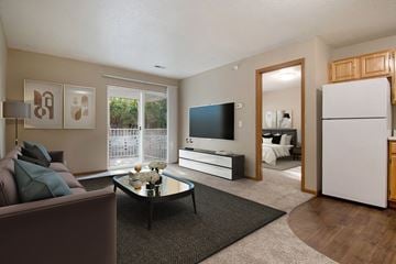 Council Bluffs apartment for rent - A living room with a brown couch and a black coffee table.
