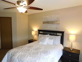 Lincoln townhouse for rent - a bedroom with a large bed and a ceiling fan