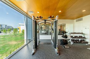 Bentonville apartment for rent - A gym with a view of the outside.