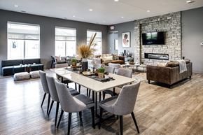 Lincoln apartment for rent - A modern dining room with a stone fireplace and a large table set for six.